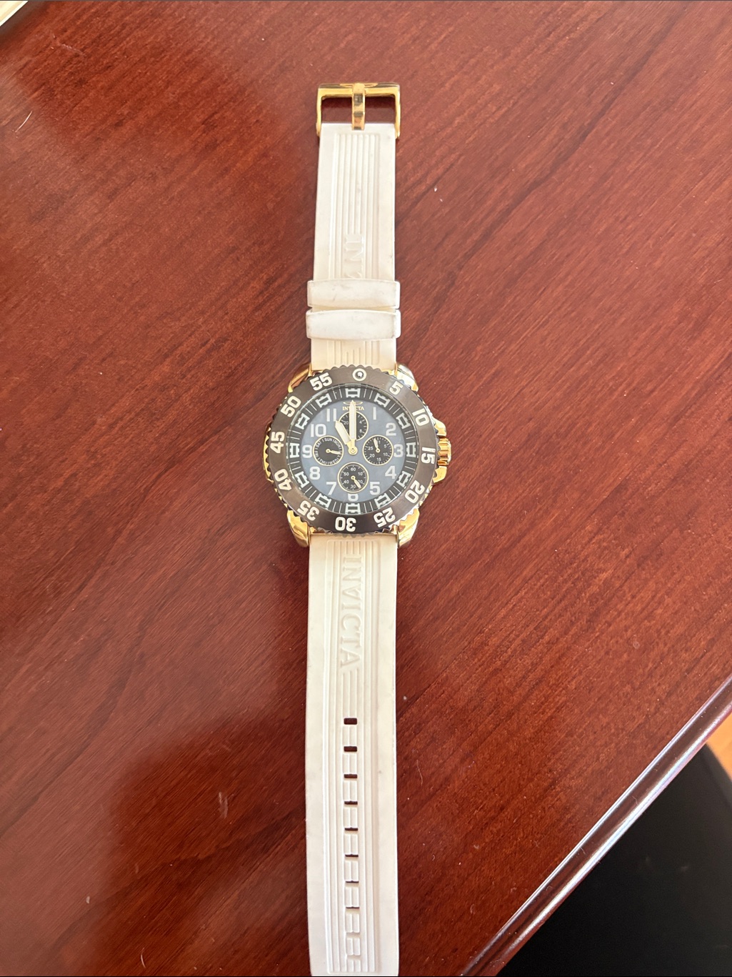 Invicta Gold And Black Chronograph Watch With White Strap